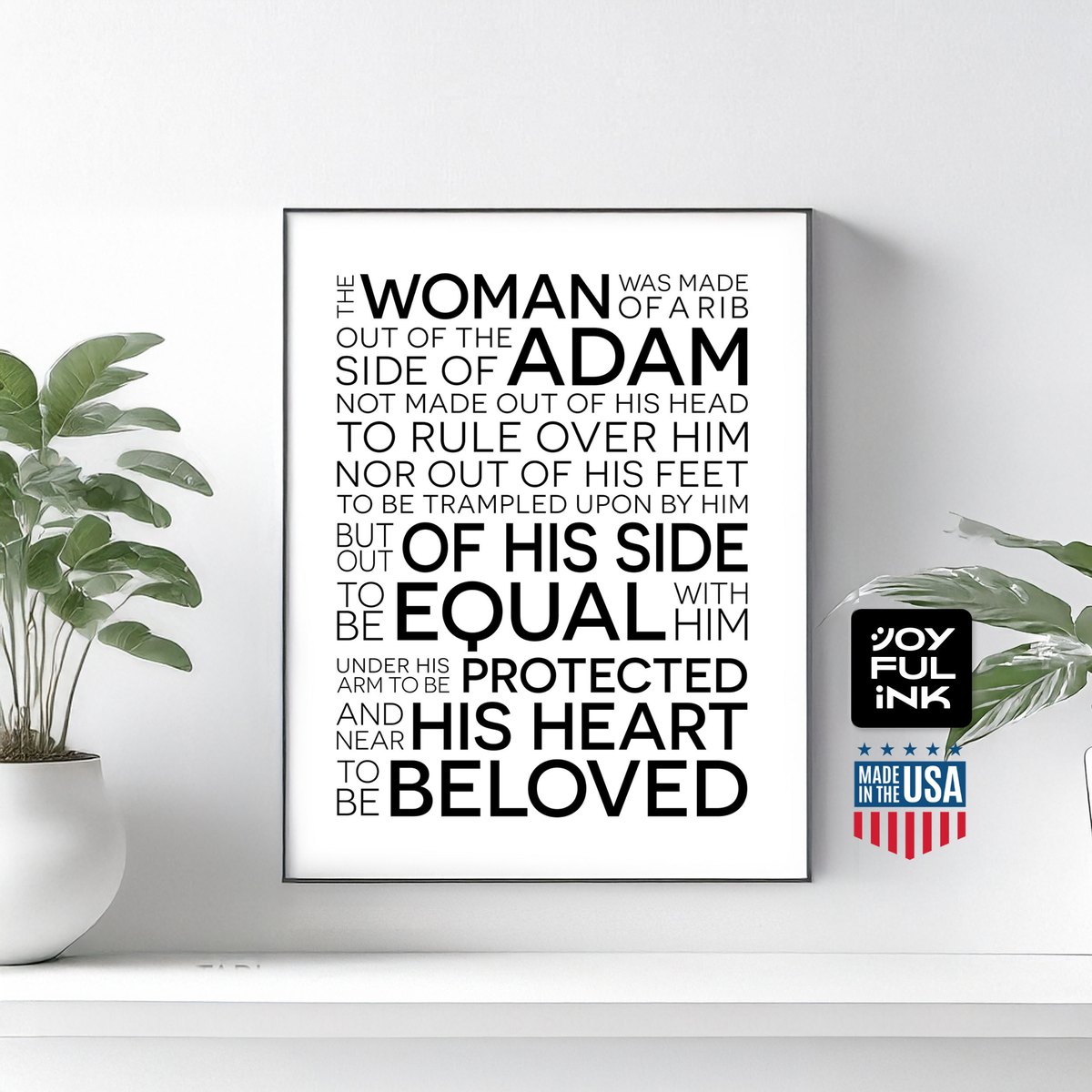Matthew Henry Adam and Eve typography wall art in a slim frame on a white shelf